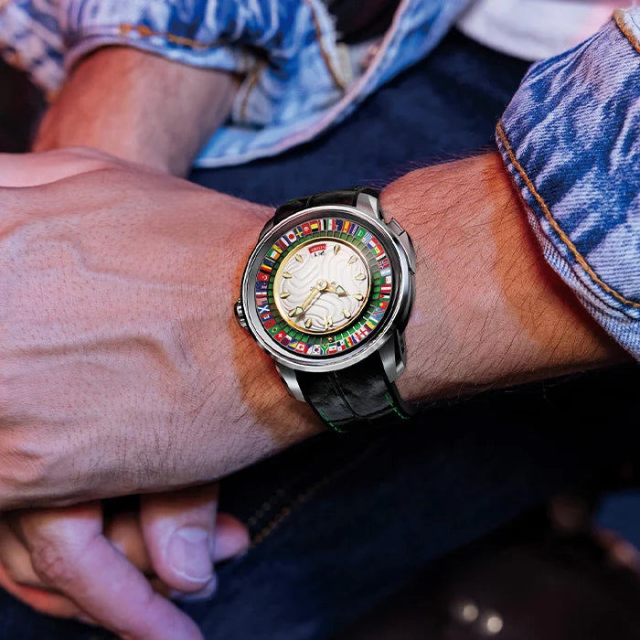 Close-up of a wrist wearing a colorful watch with a denim background