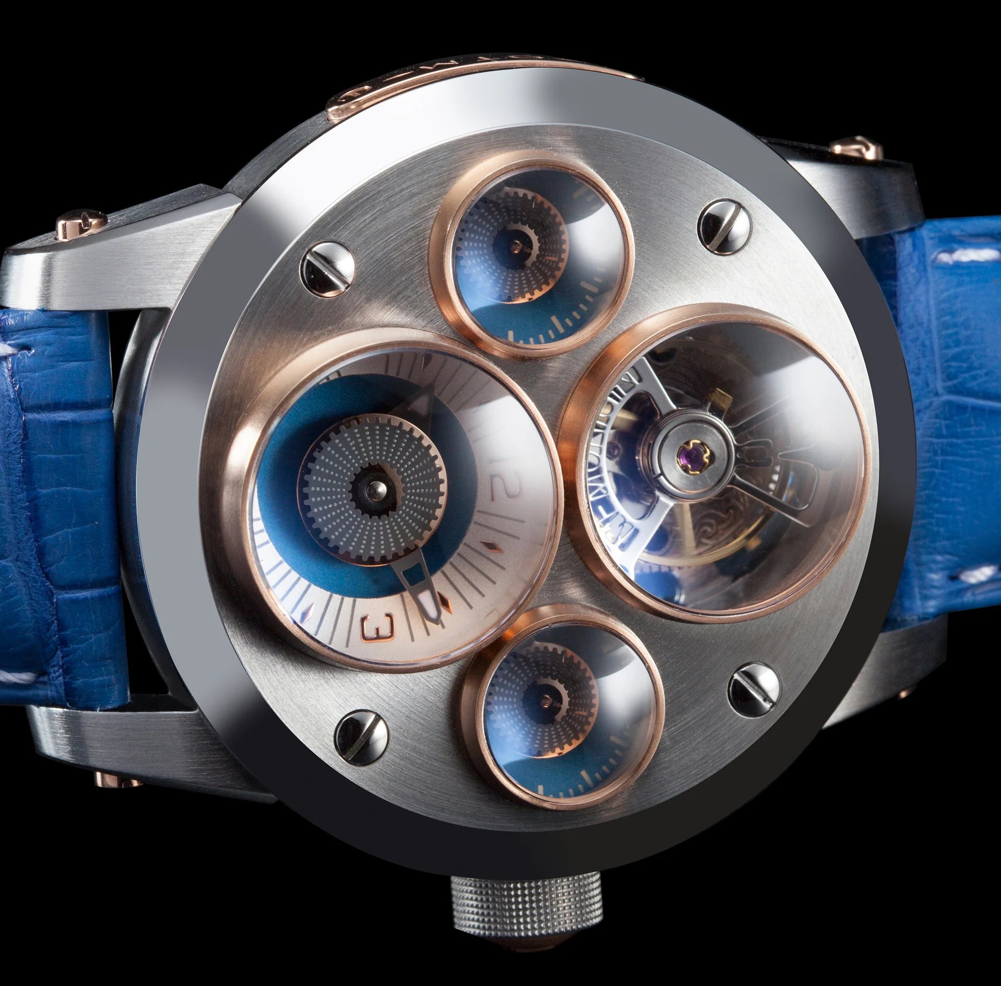 Close-up of a high-end watch with intricate design and blue strap on black background